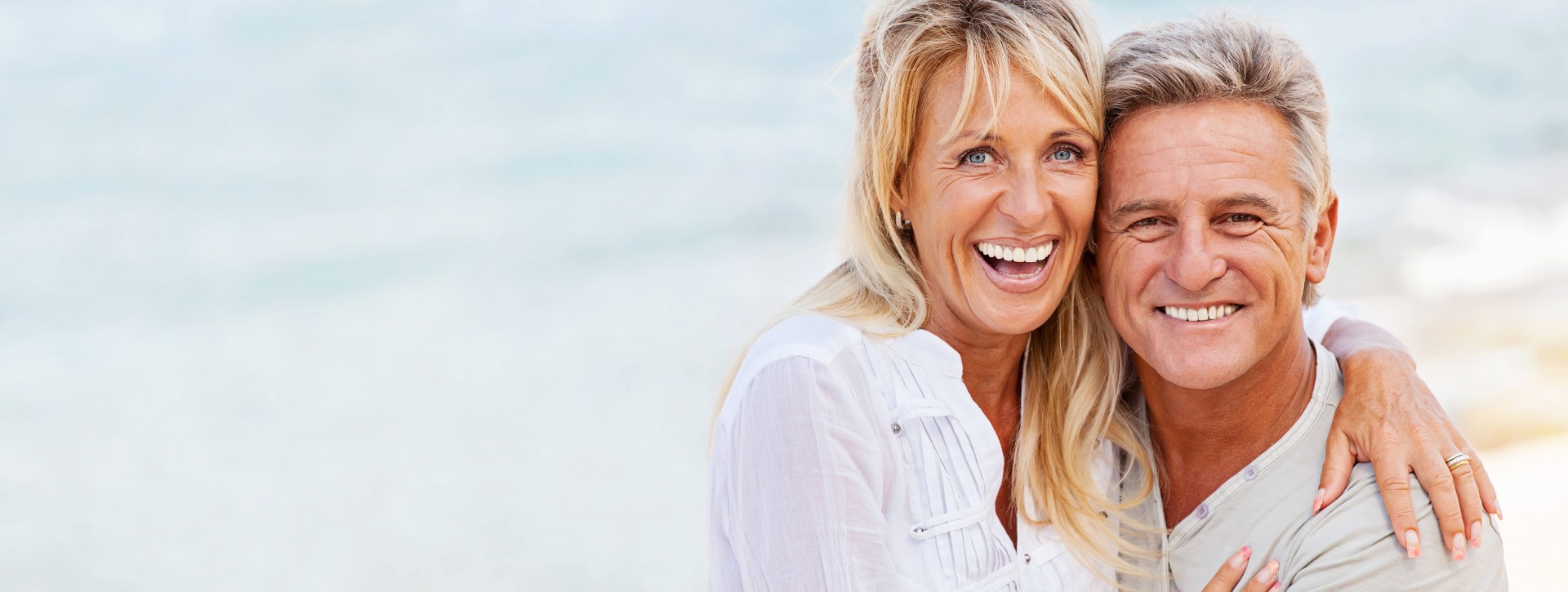 Middle aged couple hugging and smiling outside